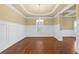 Formal dining room featuring wainscoting, tray ceilings, and a stylish chandelier at 3070 Staglin Dr, Powder Springs, GA 30127