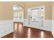 Inviting foyer featuring dark wood floors, decorative molding, and an abundance of natural light at 3070 Staglin Dr, Powder Springs, GA 30127