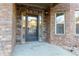 Charming front entrance with a decorative stone facade, glass door, and accent lighting at 3070 Staglin Dr, Powder Springs, GA 30127