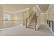 Bright hallway and staircase with wood railings and neutral carpeting at 3070 Staglin Dr, Powder Springs, GA 30127