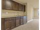 Kitchenette with dark cabinets, granite countertop, mini refrigerator, and sink at 3070 Staglin Dr, Powder Springs, GA 30127