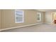 Spacious living room has neutral walls, two large windows, and plush carpeting at 3070 Staglin Dr, Powder Springs, GA 30127