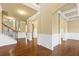 Spacious living room boasting elegant columns, wainscoting, and gleaming hardwood floors at 3070 Staglin Dr, Powder Springs, GA 30127