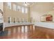 Expansive living room with hardwood floors, fireplace, and large windows at 3070 Staglin Dr, Powder Springs, GA 30127