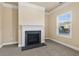 Living room showcasing a fireplace with white mantle and bright window in a neutral setting at 3070 Staglin Dr, Powder Springs, GA 30127