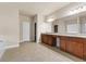 Large main bathroom features dual sinks, granite countertops, tile flooring, and a large mirror at 3070 Staglin Dr, Powder Springs, GA 30127