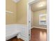 Functional mudroom with bench seating, wainscoting, and a window for natural light at 3070 Staglin Dr, Powder Springs, GA 30127