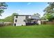 Expansive backyard featuring a two-story home with a walkout deck, fenced yard, and lush lawn at 3481 Oak Run Dr, Lithonia, GA 30038