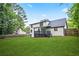 Grassy backyard featuring a two-story home with a covered porch and fenced yard, creating an ideal space for outdoor enjoyment at 3481 Oak Run Dr, Lithonia, GA 30038