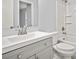Bright bathroom featuring a gray vanity, white sink, and shower/tub combo at 3481 Oak Run Dr, Lithonia, GA 30038