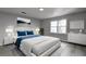 Bedroom with a blue accent bedspread, light colored walls, a window and wood floors at 3481 Oak Run Dr, Lithonia, GA 30038