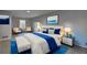 Well lit bedroom with ample seating, decor and a plush bed with blue accents at 3481 Oak Run Dr, Lithonia, GA 30038