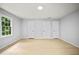 Bedroom with a window, wood floors and three white doors at 3481 Oak Run Dr, Lithonia, GA 30038