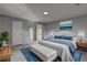 Spacious bedroom with light floors, a queen size bed with blue accents, and modern decor at 3481 Oak Run Dr, Lithonia, GA 30038