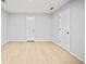 Spacious bedroom with light wood floors, white walls and two white doors at 3481 Oak Run Dr, Lithonia, GA 30038