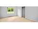 Neutral bedroom featuring light wood floors, a window and a closet at 3481 Oak Run Dr, Lithonia, GA 30038