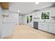 Well-lit kitchen featuring white cabinetry, stainless steel appliances, and a view to the outside at 3481 Oak Run Dr, Lithonia, GA 30038