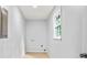 Minimalist laundry room with a window, hookups, and light wood floor at 3481 Oak Run Dr, Lithonia, GA 30038