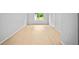 Large, bright living room features hardwood floors, a window, and a closet at 3481 Oak Run Dr, Lithonia, GA 30038