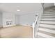 Open living room featuring hardwood floors, a fireplace, and stairs leading to the upper level at 3481 Oak Run Dr, Lithonia, GA 30038