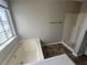 Bathroom features a garden tub and a walk-in shower in a naturally lit space at 870 Pine Shoals Dr, Atlanta, GA 30349