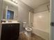 A bathroom featuring a vanity with modern fixtures, toilet, and a shower-tub combo at 870 Pine Shoals Dr, Atlanta, GA 30349