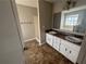 Bathroom featuring double vanity with white cabinetry, a shower, and a large tub at 870 Pine Shoals Dr, Atlanta, GA 30349