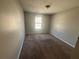 A standard bedroom with neutral walls, carpet flooring, and a single window offering natural light at 870 Pine Shoals Dr, Atlanta, GA 30349
