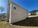 Side exterior elevation of the two-story home with siding, and view of the lawn and surrounding landscape at 870 Pine Shoals Dr, Atlanta, GA 30349