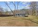 Wide backyard showcasing the home's exterior and a spacious lawn with trees at 2494 Baxter Rd, Atlanta, GA 30315