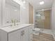 Bathroom with white tile, double sink vanity, and glass shower at 2494 Baxter Rd, Atlanta, GA 30315