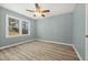 This light-filled bedroom offers wood-look flooring, a ceiling fan, and a neutral wall color at 2494 Baxter Rd, Atlanta, GA 30315