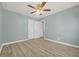 This bedroom includes wood-look floors, a ceiling fan, and a closet at 2494 Baxter Rd, Atlanta, GA 30315