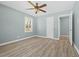 Bright bedroom featuring wood-look flooring, a ceiling fan, and a window at 2494 Baxter Rd, Atlanta, GA 30315