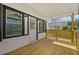 Covered front porch with wooden flooring and a decorative yellow horizontal slat railing at 2494 Baxter Rd, Atlanta, GA 30315