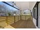 Covered front porch with wooden flooring and a decorative yellow horizontal slat railing at 2494 Baxter Rd, Atlanta, GA 30315