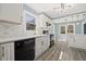 Bright kitchen features white cabinets, black appliances, and luxury vinyl plank flooring at 2494 Baxter Rd, Atlanta, GA 30315