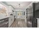 Bright kitchen features white cabinets, stainless steel appliances, and luxury vinyl plank flooring at 2494 Baxter Rd, Atlanta, GA 30315