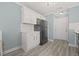 Bright kitchen features white cabinets, black appliances, and luxury vinyl plank flooring at 2494 Baxter Rd, Atlanta, GA 30315