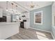 Modern kitchen with white cabinets, stainless appliances, stylish light fixtures and luxury vinyl flooring at 2494 Baxter Rd, Atlanta, GA 30315