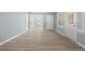 Bright, open-concept living room with modern floors and fresh blue walls with access to front door at 2494 Baxter Rd, Atlanta, GA 30315