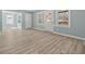 Bright, open-concept living room with modern floors and fresh blue walls with access to back porch at 2494 Baxter Rd, Atlanta, GA 30315