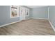Bright, open-concept living room with modern floors and fresh blue walls with access to back porch at 2494 Baxter Rd, Atlanta, GA 30315