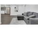 Finished basement features a comfortable gray sofa set, and an open concept space with durable wood-look floors at 2497 Wawona Ne Dr, Brookhaven, GA 30319