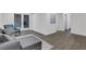 Finished basement area with comfortable seating, wood-look floors, and a view of the outdoor patio at 2497 Wawona Ne Dr, Brookhaven, GA 30319
