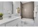 Stylish bathroom with a modern vanity, marble floors, and a tub-shower combo featuring sleek, horizontally laid tiles at 2497 Wawona Ne Dr, Brookhaven, GA 30319