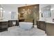 Sleek bathroom with freestanding tub, statement wall, and dual vanity areas at 2497 Wawona Ne Dr, Brookhaven, GA 30319