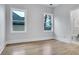 Light-filled bedroom with hardwood floors and views from two large windows at 2497 Wawona Ne Dr, Brookhaven, GA 30319