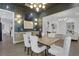 Open concept dining room with elegant chairs, stylish light fixture, and accent wall at 2497 Wawona Ne Dr, Brookhaven, GA 30319