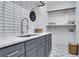 Well-organized laundry room with tile floors, modern sink, and storage solutions at 2497 Wawona Ne Dr, Brookhaven, GA 30319